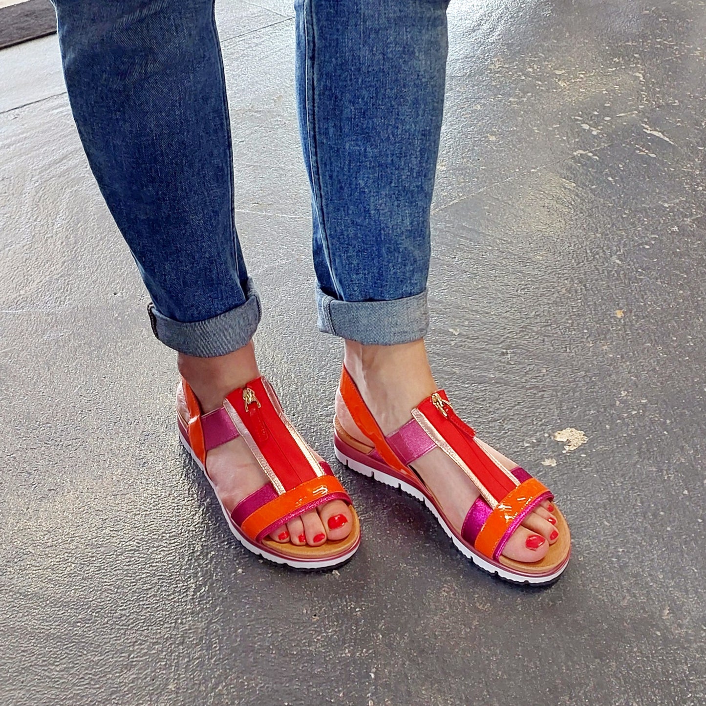 Lifestyle image of Django and Juliette orange multi leather sandal 