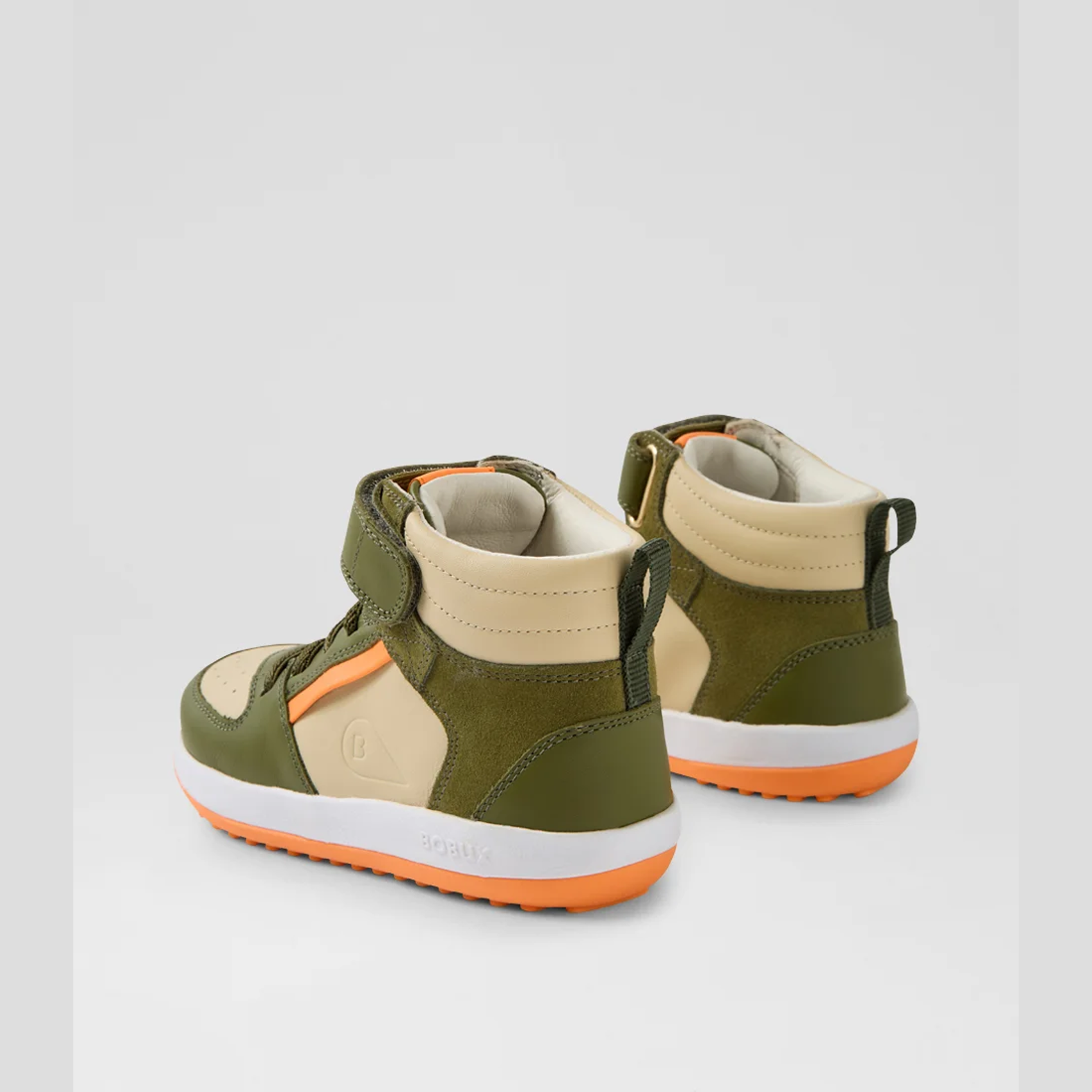 Pair of green and beige high-top sneakers with orange accents on a light gray background